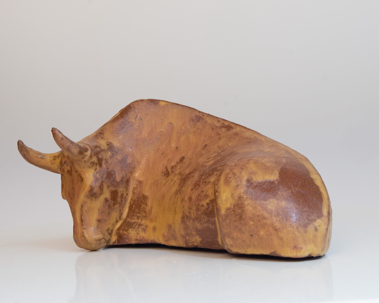 Liegender Stier aus Keramik mit orangebrauner Glasur